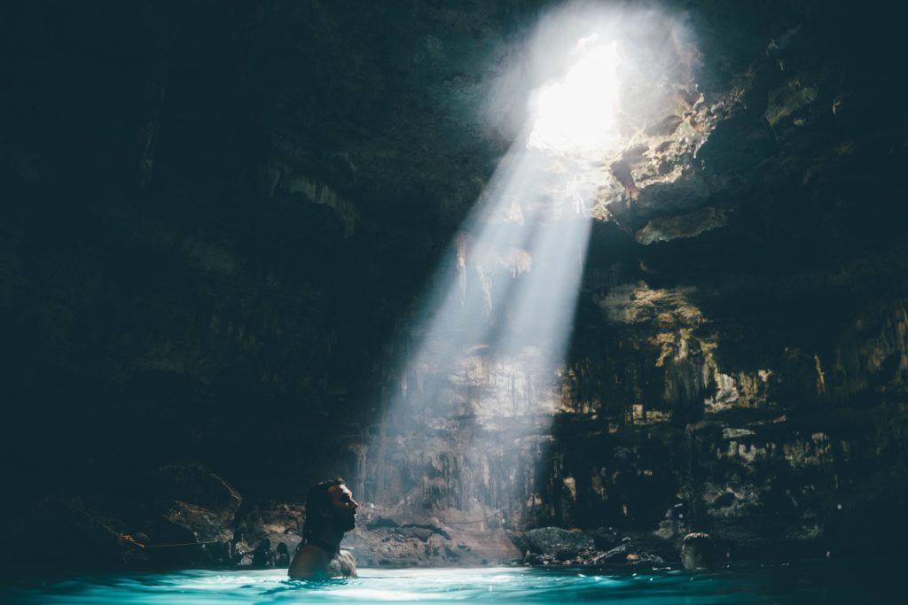 Man swimming at the cave.